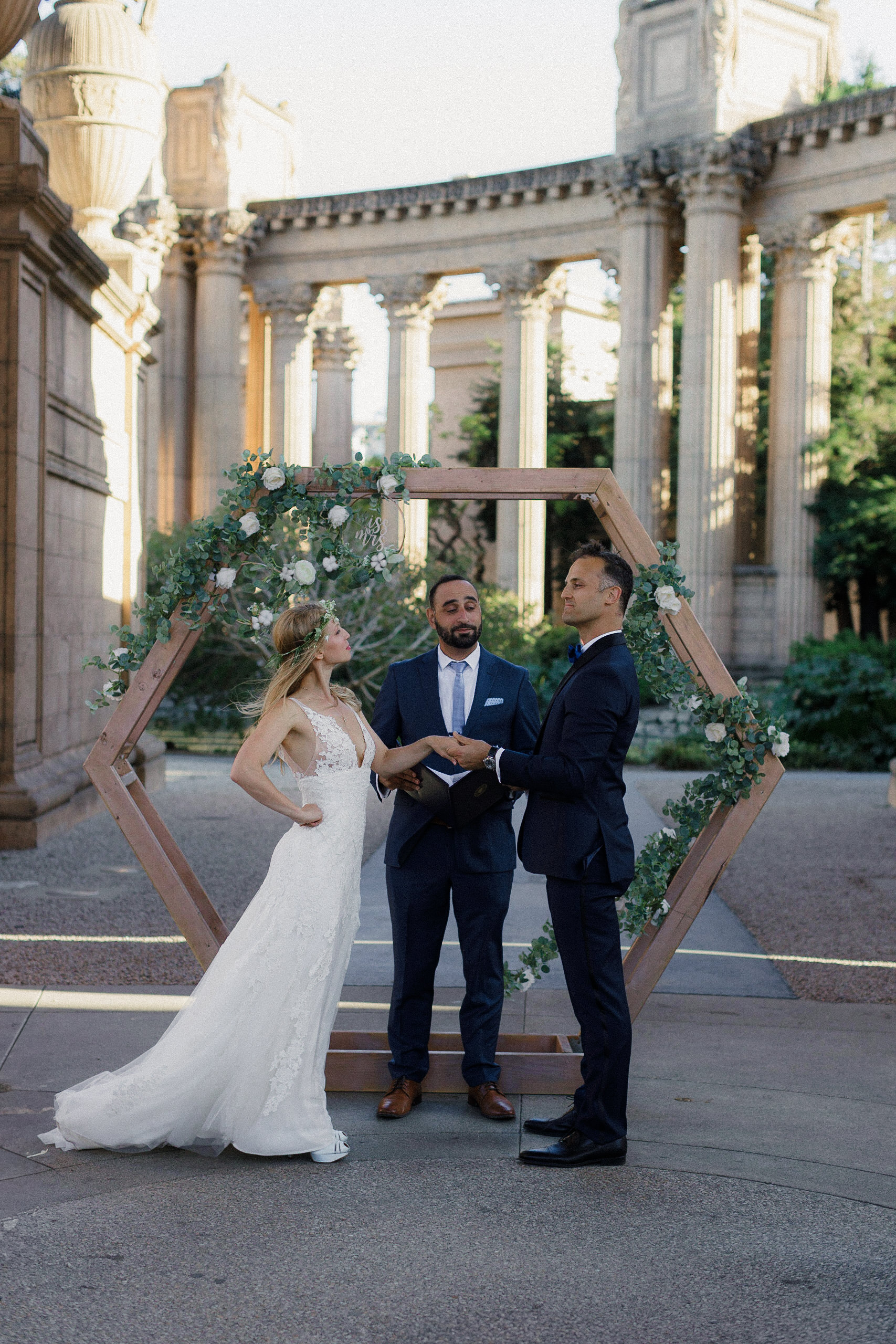 Couples Palace of Fine Arts Wedding: Floral Hexagon Under Clear Sky, Majestic Stone Columns.