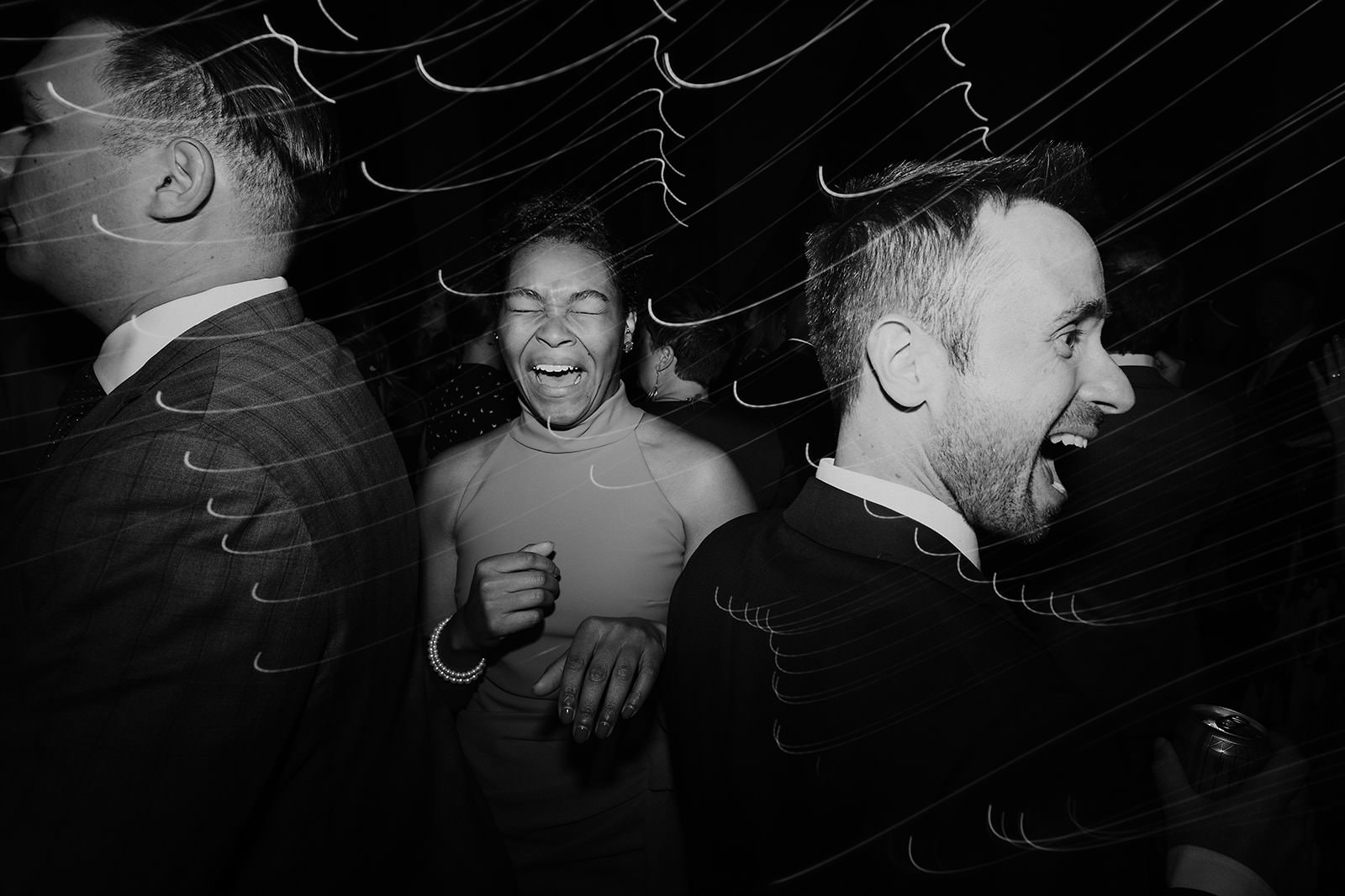 Elegant Black & White Wedding Photo: Joyful Laughter & Dance at Cuffey Cove, Dynamic Light Streaks.