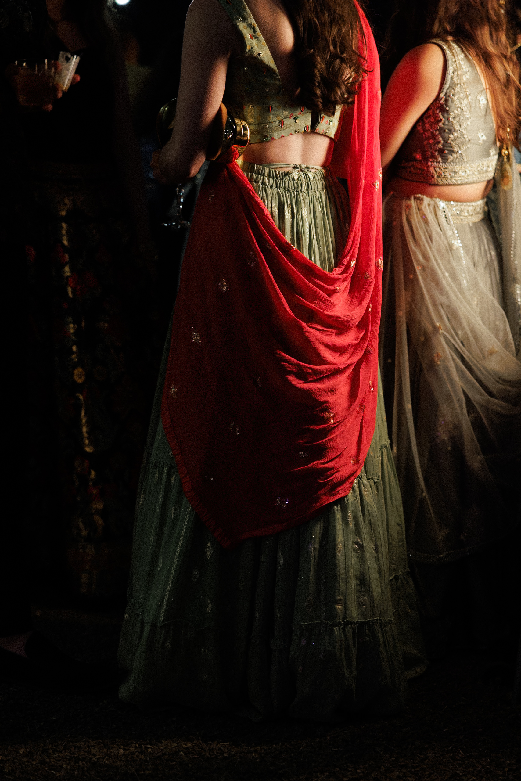 Elegant Indian Women in Ornate Blouses & Skirts at Wedding, Northern California Evening.