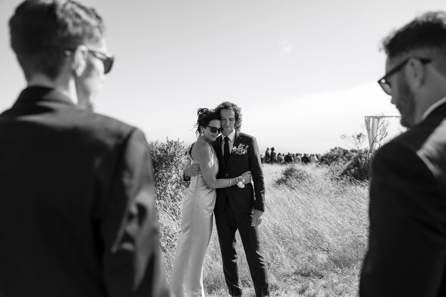 Northern California wedding at Cuffey Cove: Couple in formal attire embraced under sunny skies.