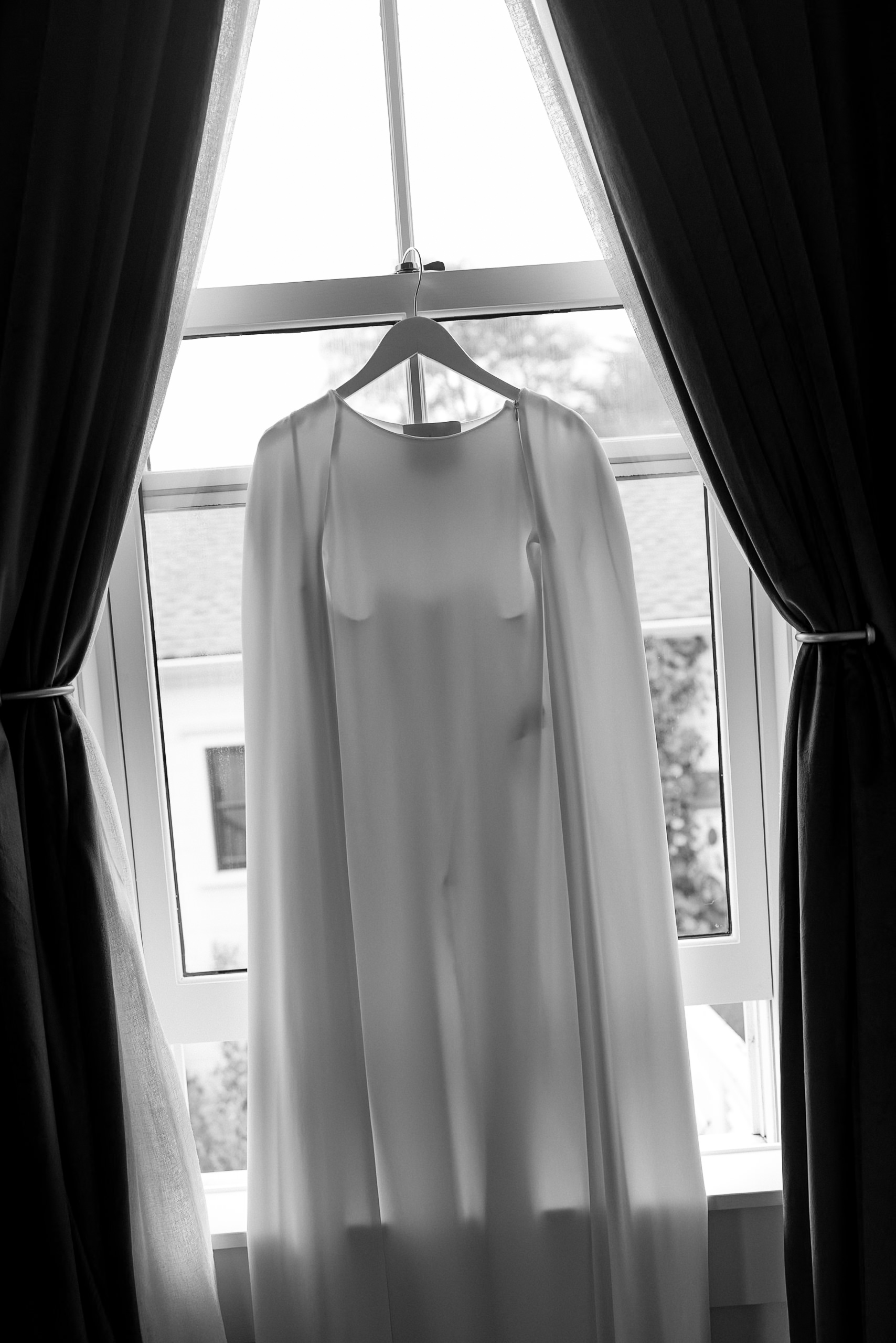 Elegant Mendocino Wedding Dress in Window Light, Highlighting Delicate Fabric.