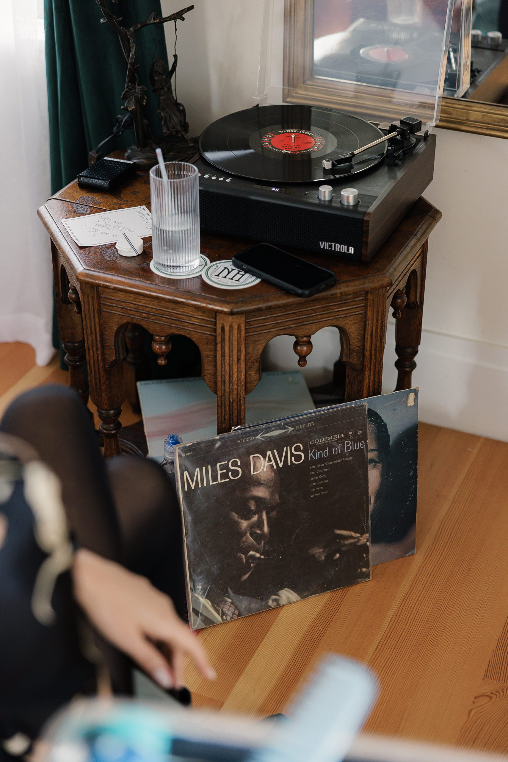 Elegant Mendocino Wedding Scene: Vintage Record Player, Miles Davis Vinyl, Cozy Setting.