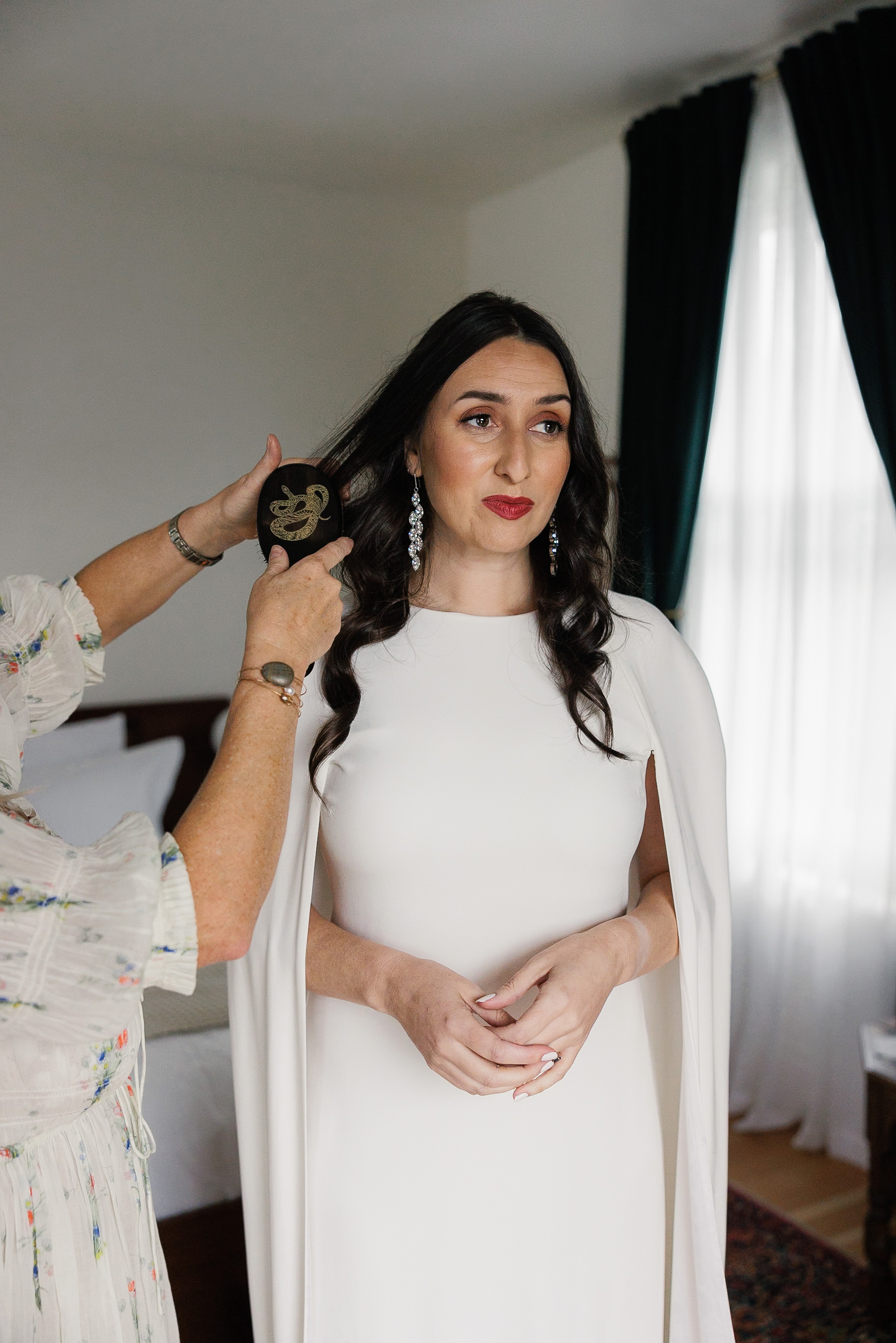 Capture Mendocino Wedding Elegance: Brides Hairstyle Perfection with White Dress & Drop Earrings.