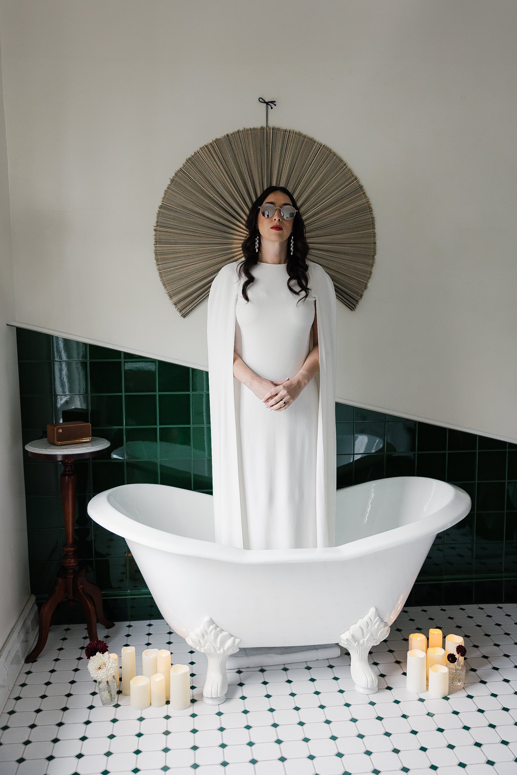 Elegant bridal portrait in vintage clawfoot tub with candles on Mendocino green tiles.