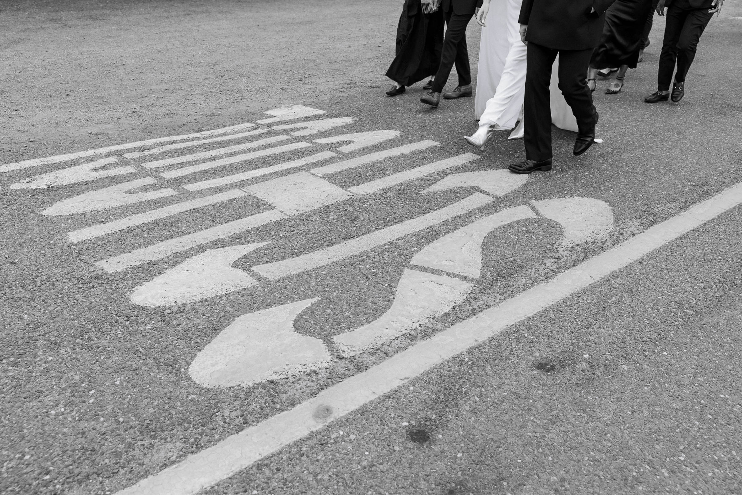 Black-and-white street scene in Mendocino featuring people walking; emphasizes movement and mood.