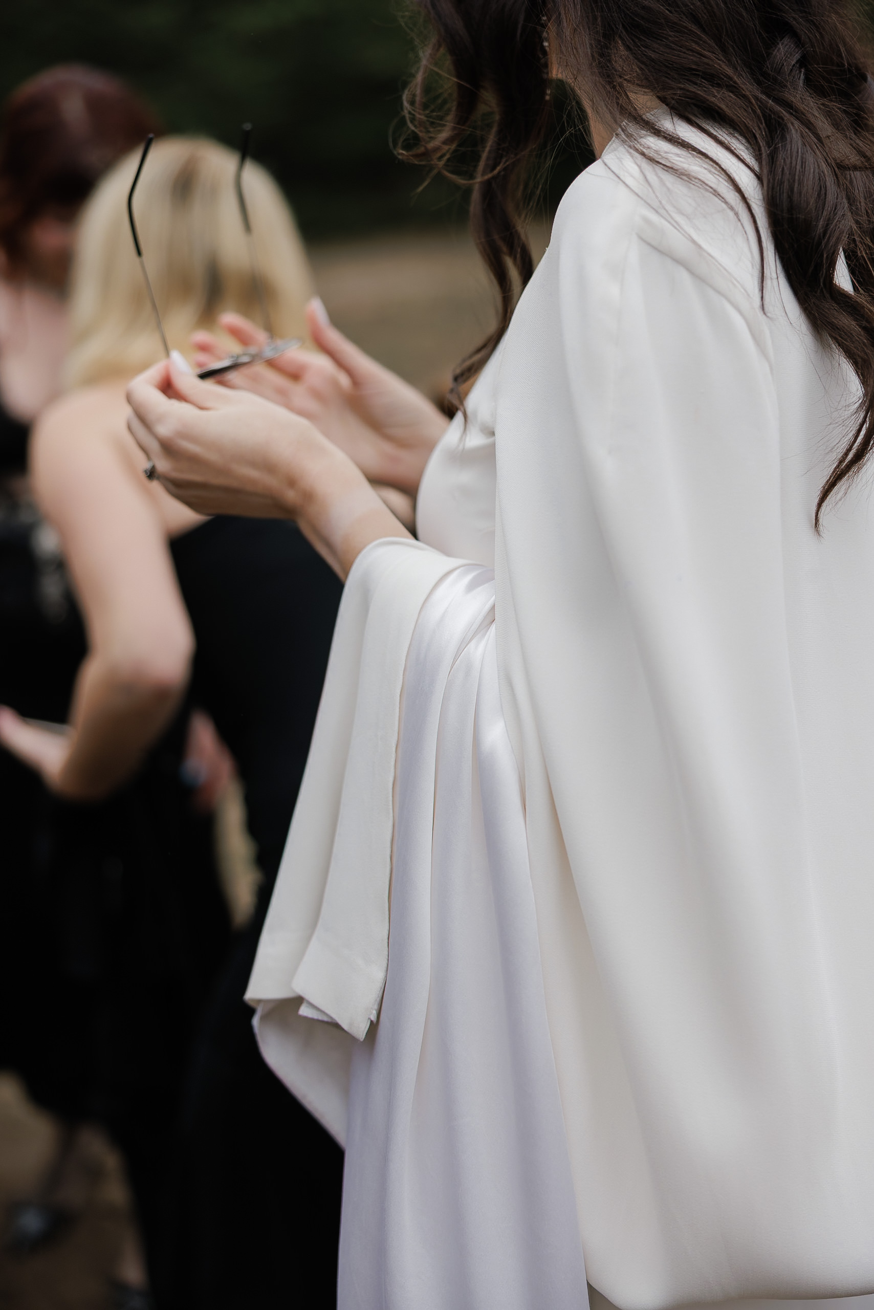 Elegant bride in Mendocino, flowing white dress, long dark hair, serene outdoor setting.