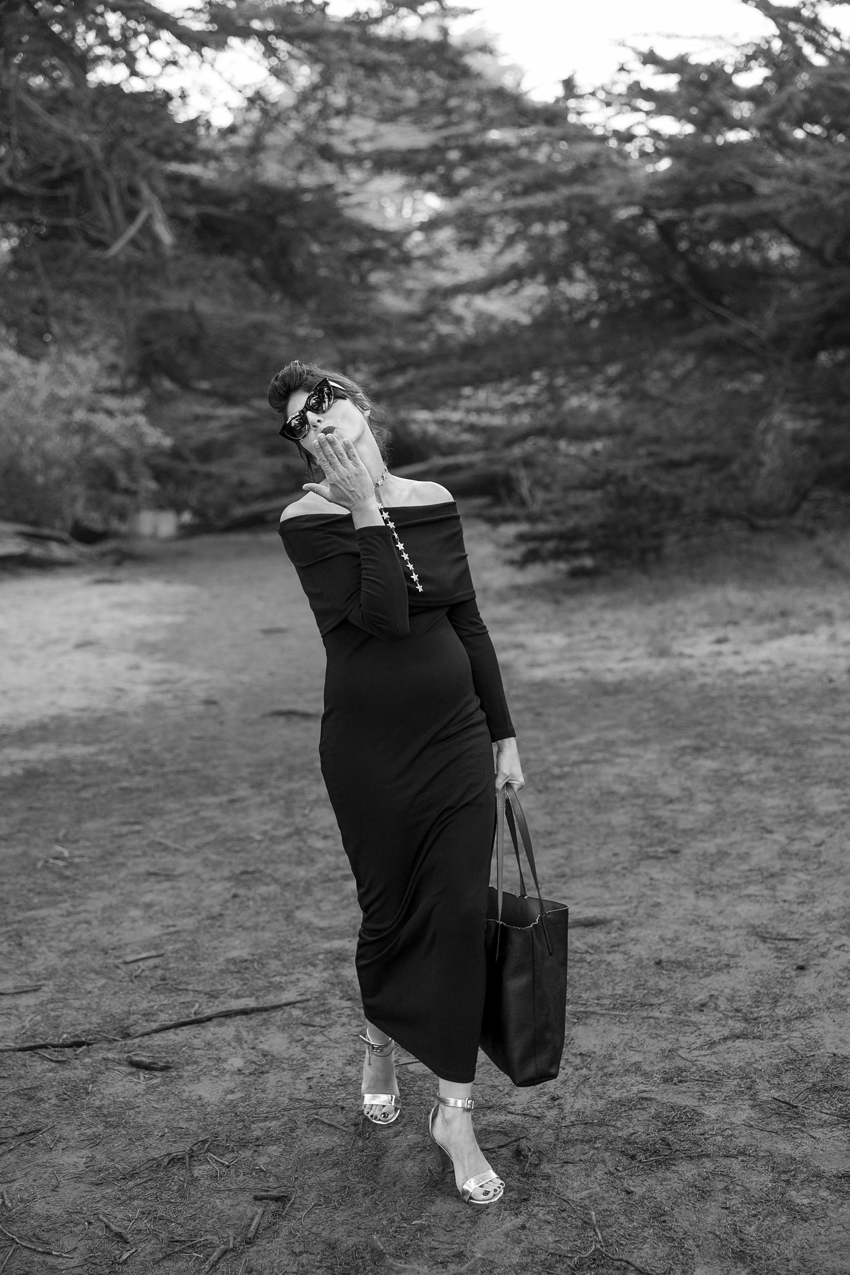 Timeless Wooded Path Stroll: Elegant Off-Shoulder Dress and Sunglasses in Black & White Photography.