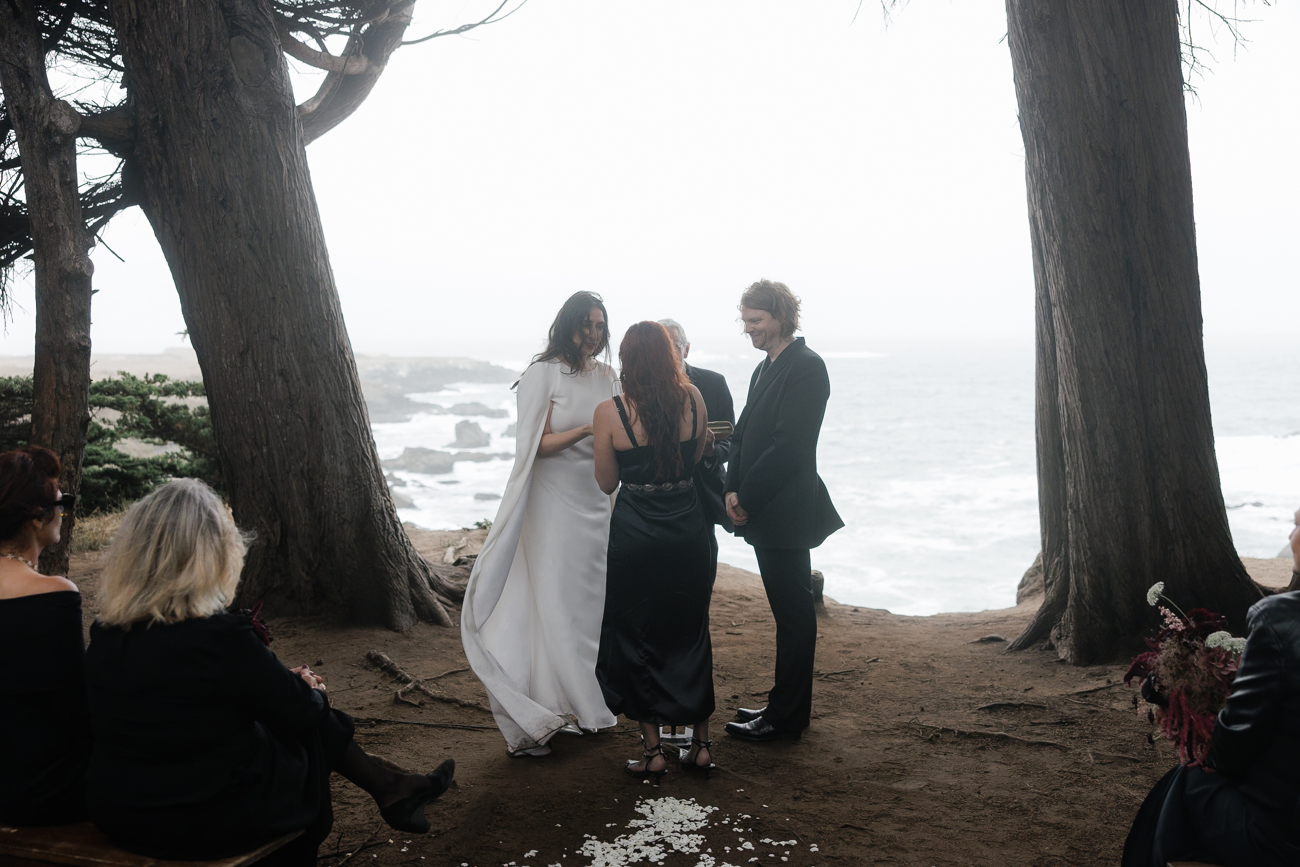 Stunning Mendocino Cliffside Wedding: Couple Exchange Vows Overlooking Foggy Ocean.