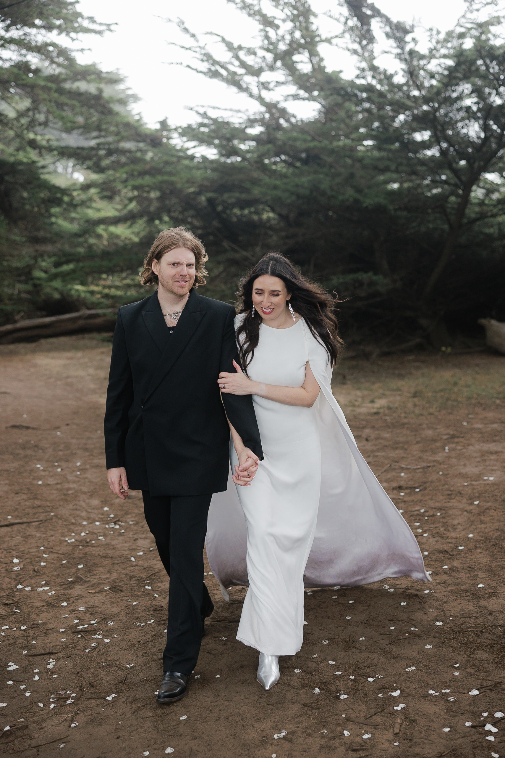 High-End Wedding Photography: Captivating Mendocino Forest Scene, Elegant White Dress & Black Suit Duo.