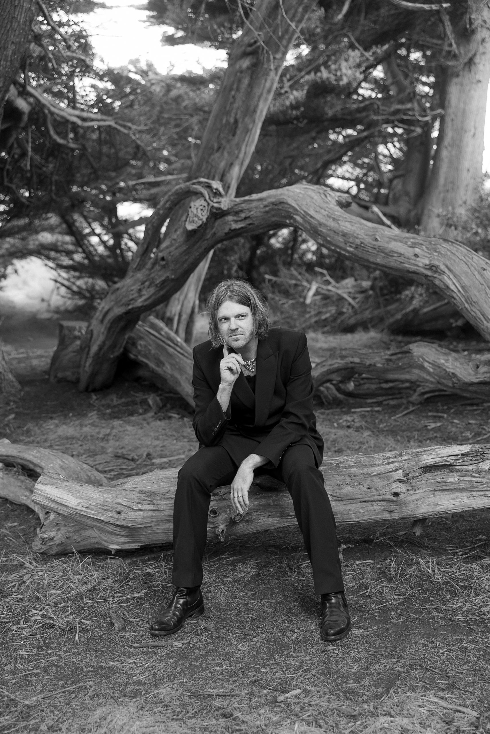 Elegant Black and White Wedding Portrait: Thoughtful Groom in Mendocino Forest.