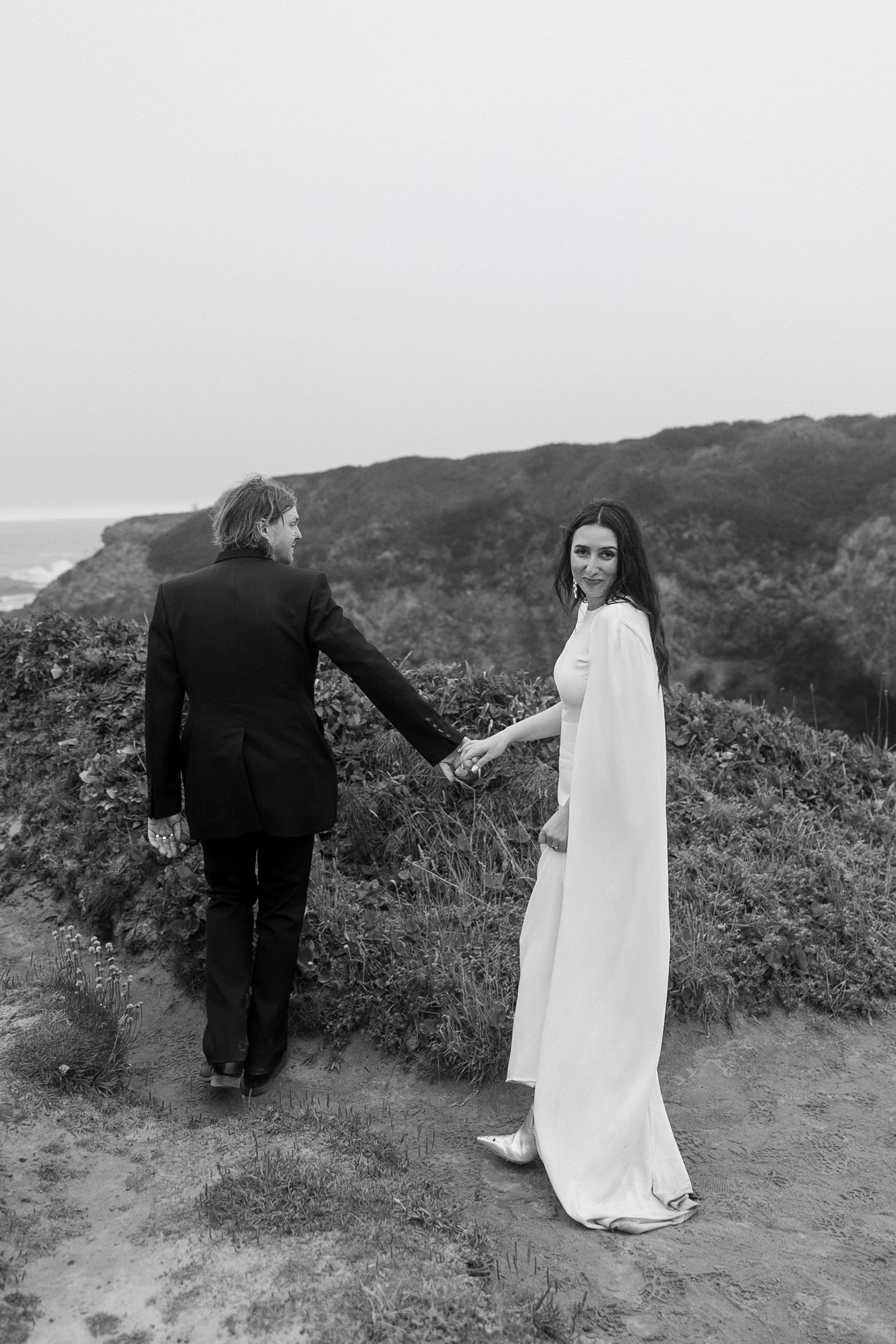 Black & White Wedding Portrait: Elegant Couple on a Grassy Path, Mendocino Coast Backdrop.