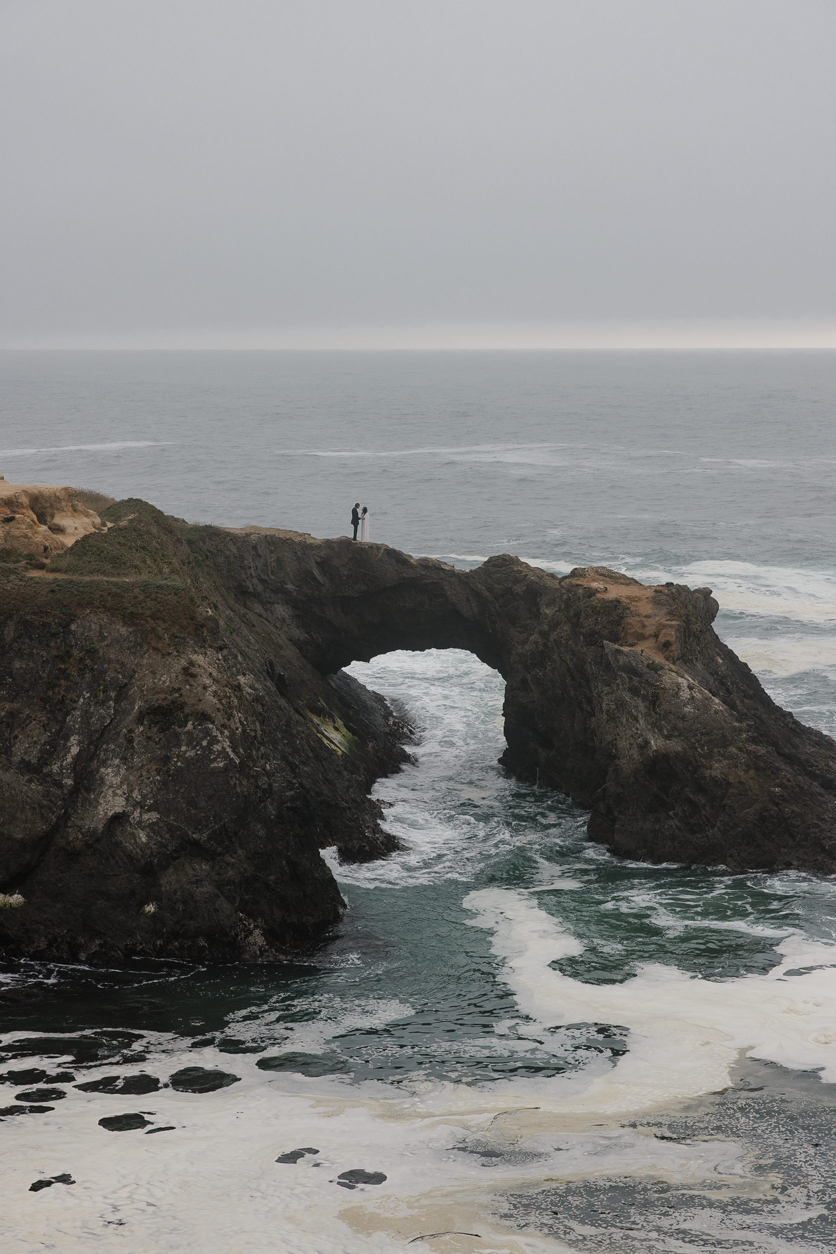 Stunning Oceanside Wedding Photography: Dramatic Mendocino Rock Arch & Serene Seascape.