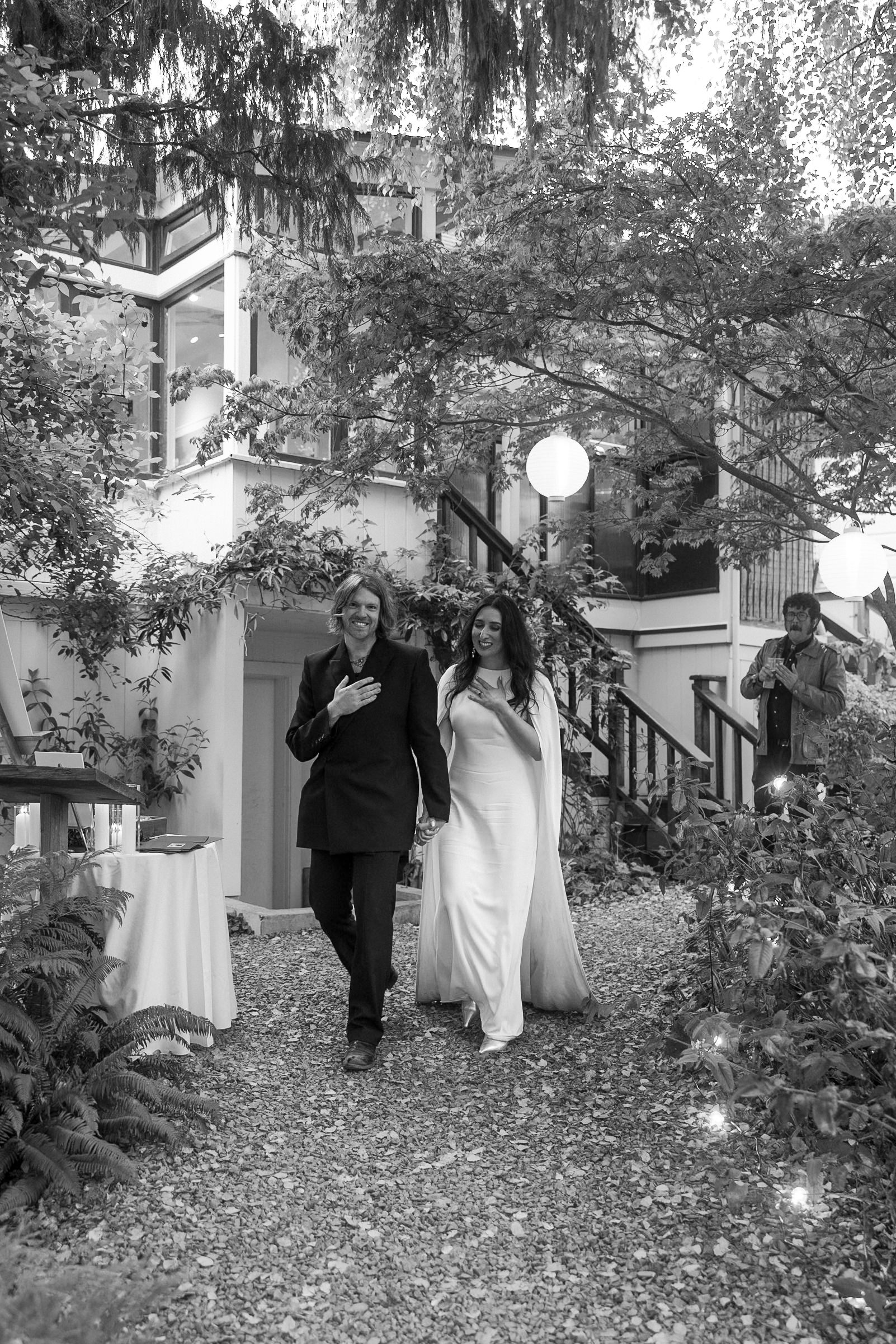 Capturing a couples grace in Mendocinos enchanting gardens, embraced by lanterns and lush greenery.
