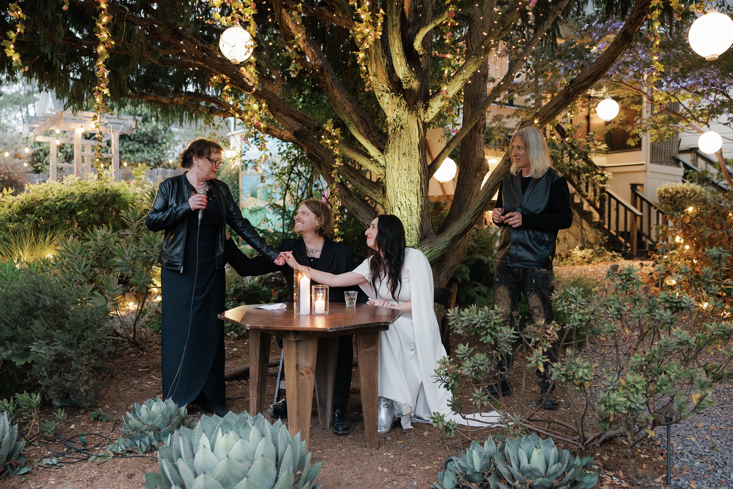 Elegant Mendocino outdoor wedding: bride in white, groom by side, guests share heartfelt moments.
