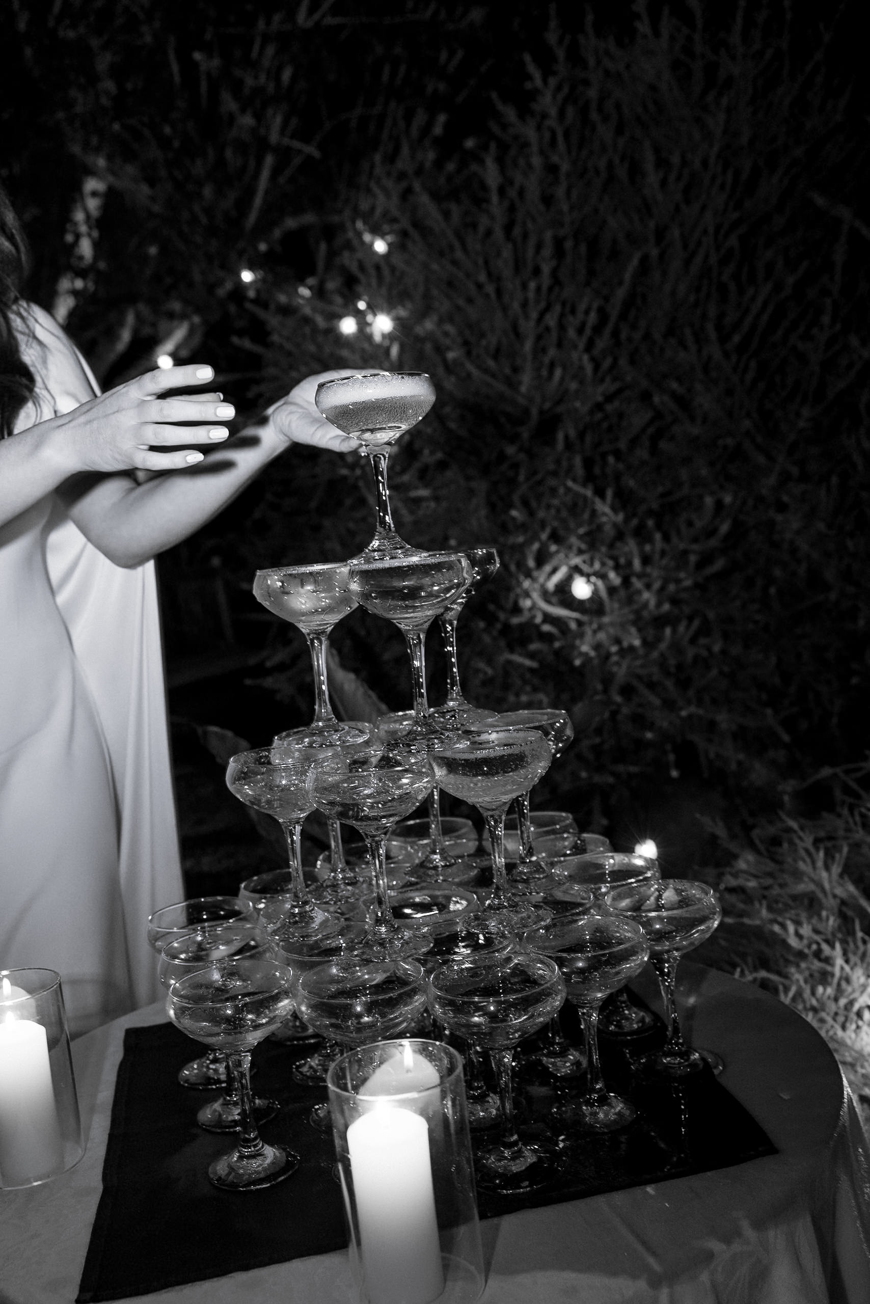 Elegant black-and-white champagne tower photo in Mendocino wedding: timeless, romantic setting.
