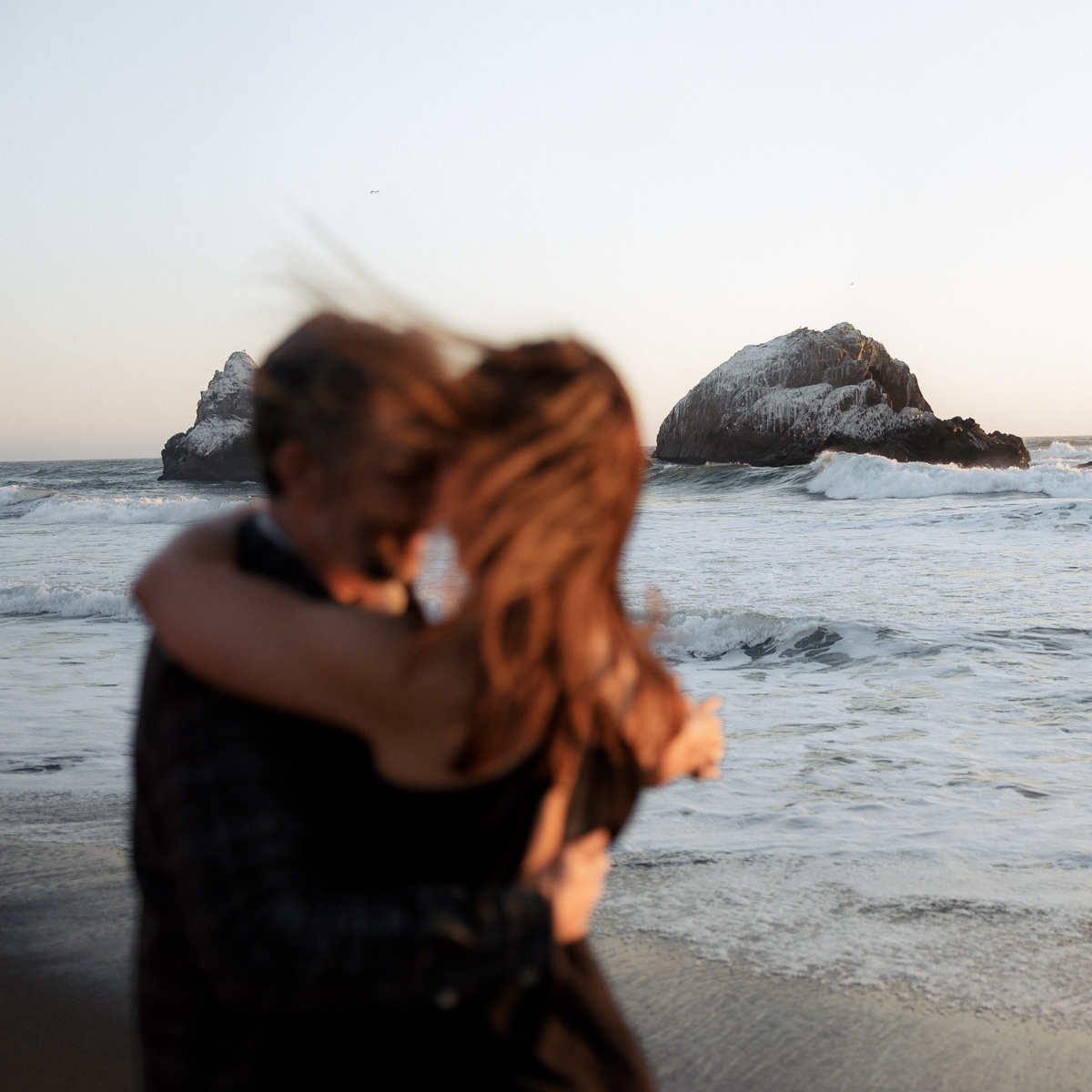 Engaged Couple on Scenic San Francisco Beach at Sunset - Professional Wedding Photography.