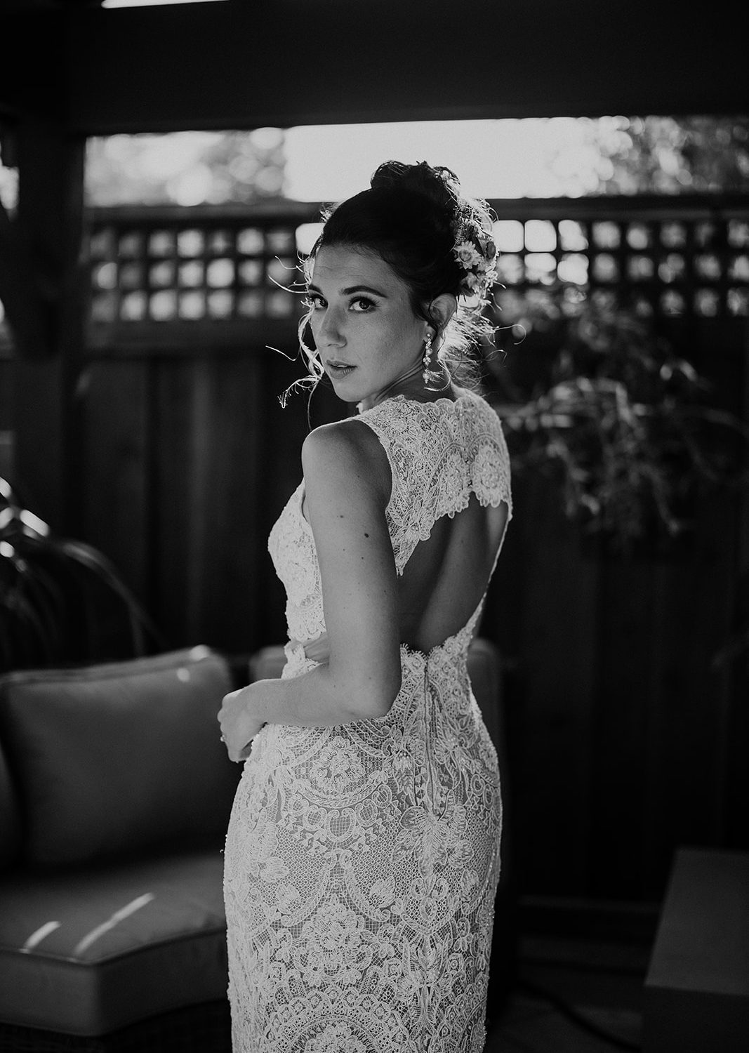 Elegant Bride in Lace Dress: Timeless Black & White Portrait on California Patio.